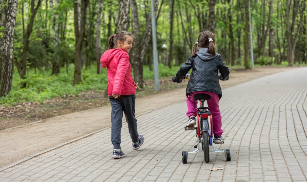 two-girls-riding-kids-bike