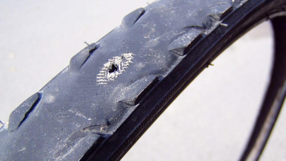 bicycle tire with worn rubber and hole