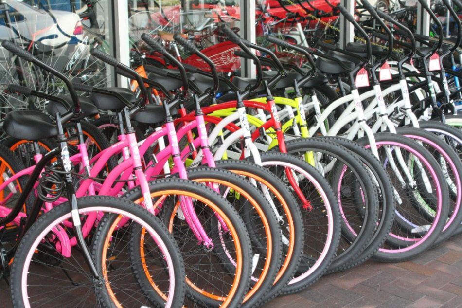 Childrens bikes lined up outside shop all in different colors