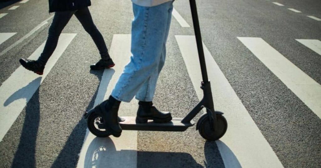 Electric scooter being riding across a crossing 3