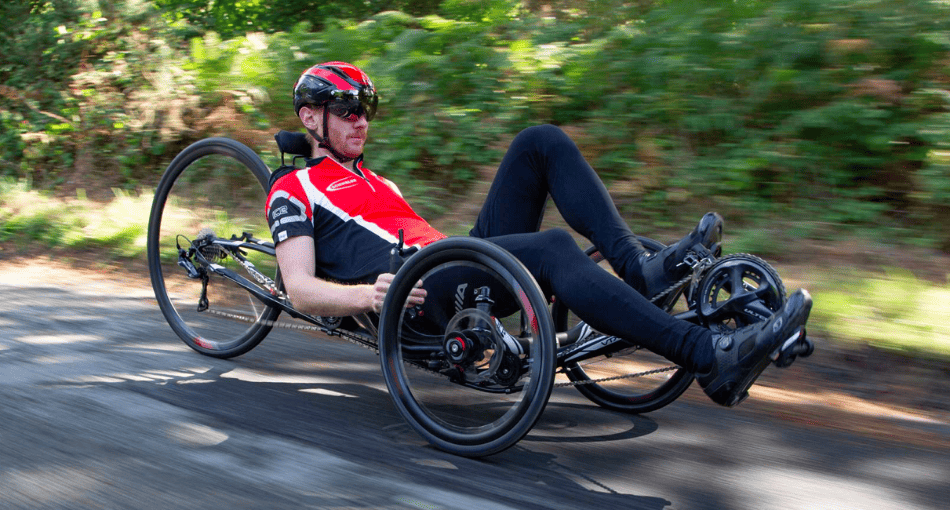 ICE Trail electric recumbent adult tricycle woman riding along gravel path 2