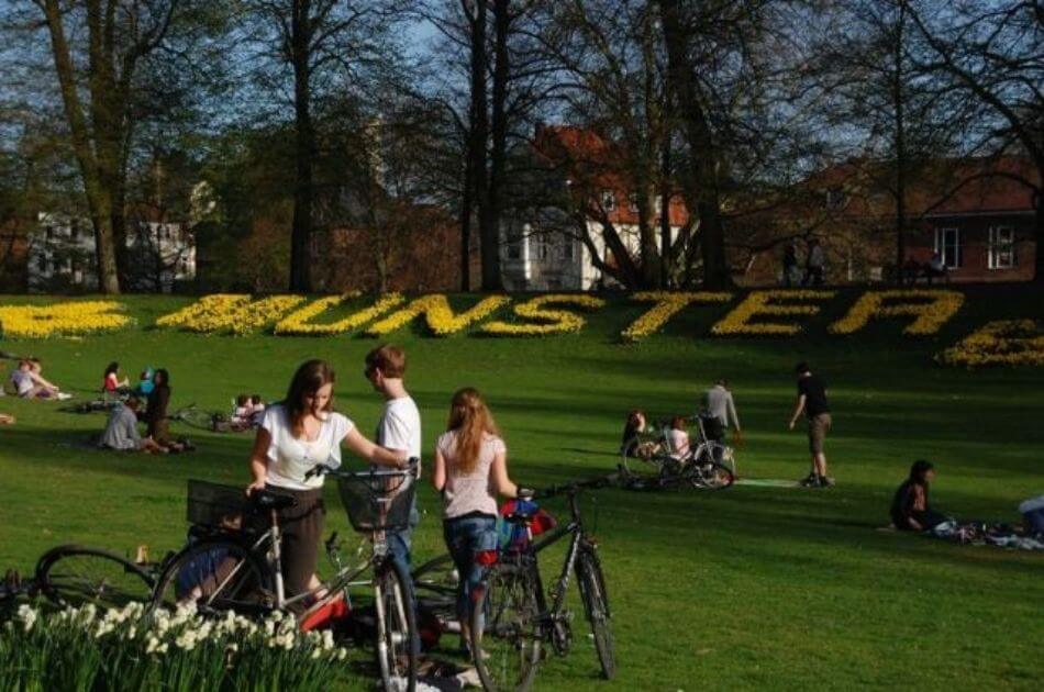 people in Munster Germany park with bicycles