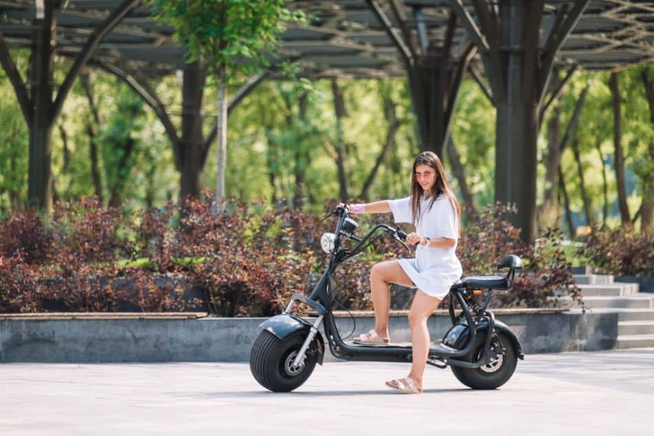 woman and an electric scooter modern girl new generation electric transport