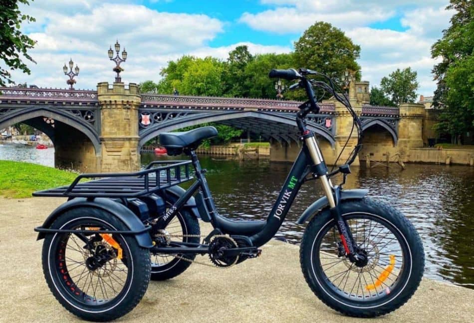 Electric Tricycle by a river. Photo Credit Unsplash.