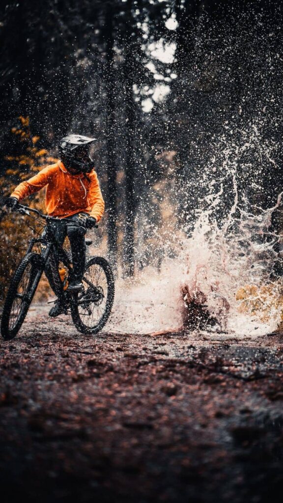 Mountain biker splashing on trail