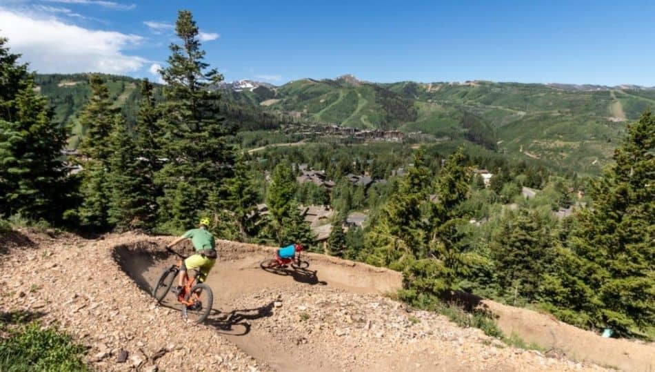 Two mountain bikers riding a berm in Deer Valley Resort Bike Park