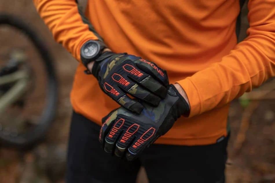 Man in orange shirt wearing Dakine Cross X mountain bike gloves1