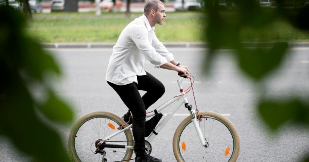 side view adult male riding bicycle street