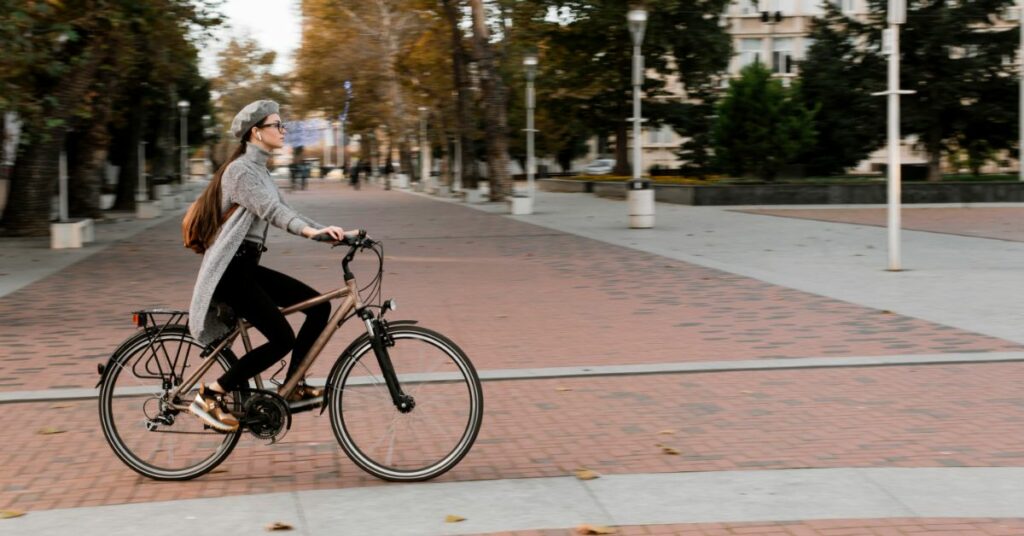 woman standing bicycle long shot